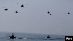 Helicopters and warships during an Iranian naval exercise in the Strait of Hormuz in January 2011