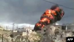 A videograb shows flames and smoke rising into the air following the bombardment of the city of Hama by security forces late last month. 