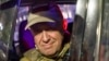 Wagner chief Yevgeny Prigozhin smiles for cameras as he departs Rostov-on-Don, Russia, on June 24 after calling his mercenary troops to stand down on a "march of justice" to Moscow.