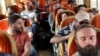 Citizens from Ukraine, Georgia, and Peru sit on a bus during their evacuation from Sudan on April 25. 