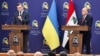 Ukrainian Foreign Minister Dmytro Kuleba (left) and Iraqi Foreign Minister Fuad Hussein hold a joint news conference in Baghdad on April 17.