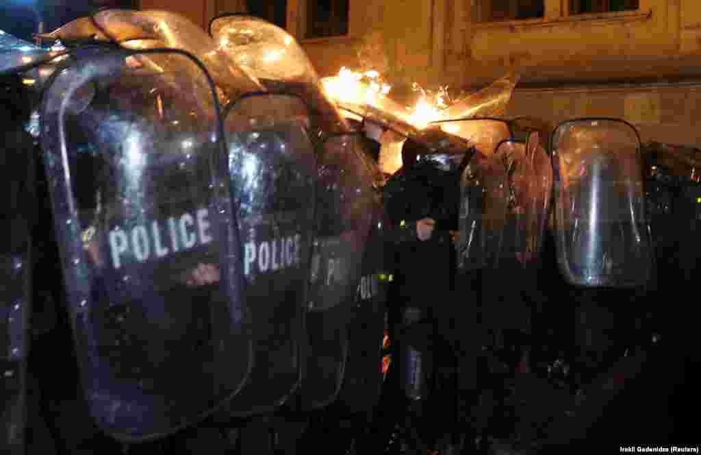 Police are hit by a firebomb during the protest. AFP reported seeing at least three Molotov cocktails thrown at police.&nbsp;