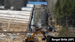 This was the scene near Finland&rsquo;s Pelkola border crossing with Russia on April 14 as excavators worked on readying a strip of the border for a new boundary fence. A green and red post marking Russian territory can be seen on the left-hand side of this photo.