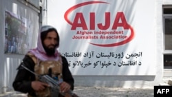 A member of the Taliban security forces keeps watch during an event organized to mark World Press Freedom Day at the Afghan Independent Journalists Association office in Kabul on May 3.