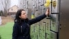 A woman whose uncle was killed by Russian troops visits a memorial to victims of the massacre in Bucha. (file photo)