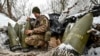 A Ukrainian serviceman prepares 155-mm artillery shells at a position near the front line in the Zaporizhzhya region.