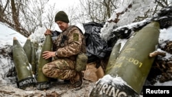 A Ukrainian serviceman prepares 155-mm artillery shells at a position near the front line in the Zaporizhzhya region.