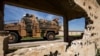 An army vehicle drives past the ruins of a building during a Turkish and Russian military patrol in the countryside of Rumaylan in Syria's northeastern Hasakeh Province bordering Turkey, on April 27.