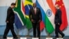 Chinese President Xi Jinping, South African President Cyril Ramaphosa, and Russian President Vladimir Putin arrive to pose for a group picture during the 10th BRICS summit in July 2018 in Johannesburg, South Africa.