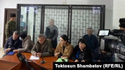 Former Kyrgyz President Almazbek Atambaev stands in a glass cage at the start of his trial at a Bishkek courthouse on December 1. 