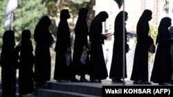 Afghan female students stand in line after they arrive for entrance exams at Kabul University earlier this year. 