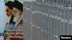 A poster of Iran's Supreme Leader Ayatollah Ali Khamenei and the late Ayatollah Ruhollah Khomeini is seen next to bank of centrifuges in what Iranian television said is a facility in Natanz last year.