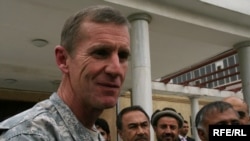 U.S. General Stanley McChrystal walks with members of the Afghan parliament in Kabul today.