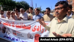 Pakistani journalists pray for colleagues killed in the line of duty on World Press Freedom Day in Peshawar on May 3.