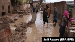 Afghans survey their damaged houses after seasonal floods in Herat on March 29. 