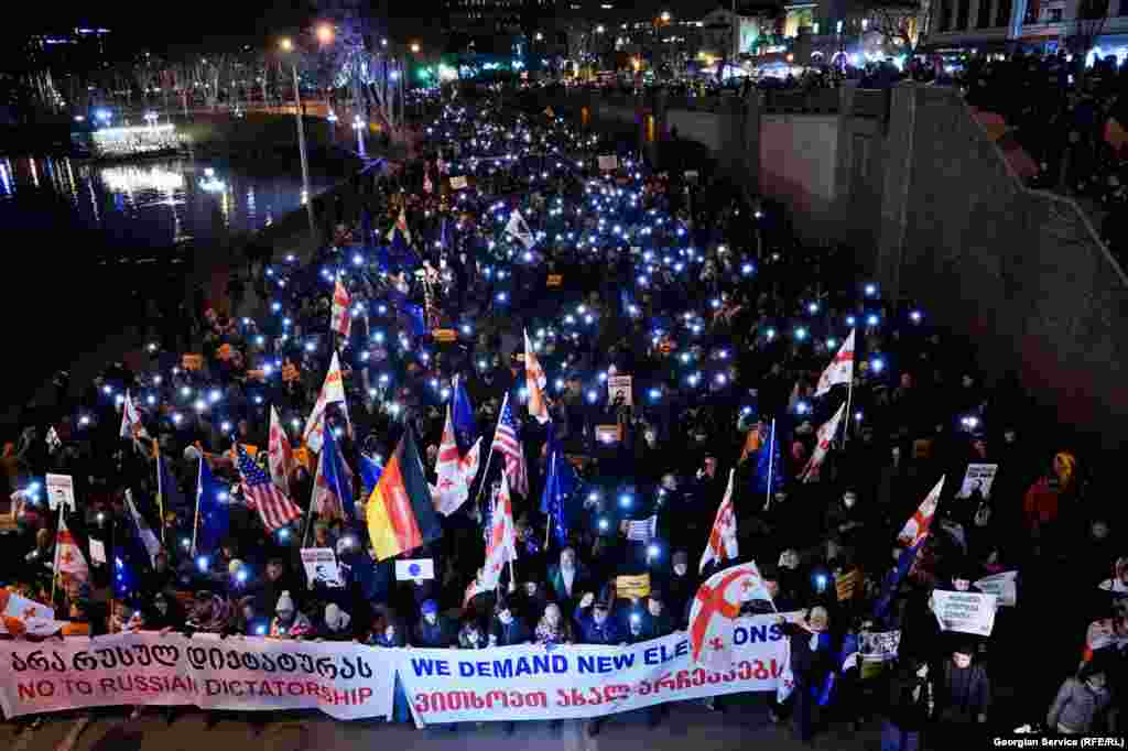 Marchers calling for new elections walk along a highway in central Tbilisi on February 15.&nbsp;