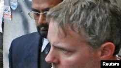 American Raymond Davis is escorted by police and officials out of court in Lahore on January 28.