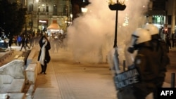 Greek demonstrators clash with riot police in Athens overnight on April 4.