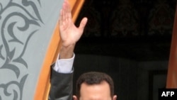 Syrian President Bashar al-Assad salutes a crowd in the town of Al-Raqqa in early November.