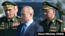 Russian President Vladimir Putin (center) visits a flight-test center in the Astrakhan region in 2019 with Chief of the General Staff Valery Gerasimov (left) and Defense Minister Sergei Shoigu.