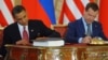 U.S. President Barack Obama (left) and his Russian counterpart, Dmitry Medvedev, sign the New START treaty in Prague on April 8, 2010.