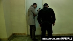 RFE/RL journalist Karlen Aslanian speaks with David Petrosian, who together with four other protesters went on a hunger strike inside a locked lecture room of Yerevan State University on November 14.