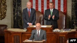 Afghan President Ashraf Ghani (center) is applauded by House Speaker John Boehner (right) and Vice President Joe Biden (left) as he arrives to addresses a joint session of Congress at the U.S. Capitol in Washington in March 2015.