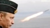 Vladimir Putin watching naval exercises during his last term as president in 2005