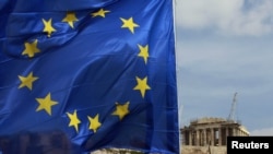 A European Union flag flies in front of the Parthenon temple in Athens