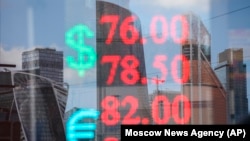 An exchange office shows the exchange rate of the Russian ruble and U.S. dollar, euro in Moscow on April 21.