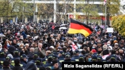 Hundreds of Saakashvili supporters on November 10 rallied outside government buildings and in front of the courtroom where his trial started without the presence of the accused.