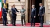 Ukrainian President Volodymyr Zelensky (center) shakes hands with France's President Emmanuel Macron as Germany's Chancellor Olaf Scholz (left), Italy's Prime Minister Mario Draghi (second from right), and Romania's President Klaus Werner Iohannis look on prior to their meeting in Kyiv on June 16. 