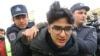 Police detain an activist in Baku ahead of the protest.