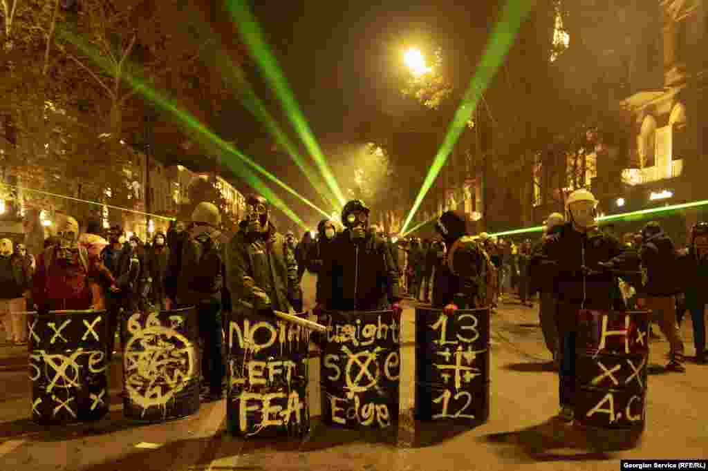 Protesters on Rustaveli Avenue armed with clubs and makeshift shields on December 4.&nbsp;