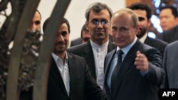 Russian President Vladimir Putin (right) gestures as he speaks with his Iranian counterpart Mahmud Ahmadinejad (left) during a meeting in Beijing in June 2012.