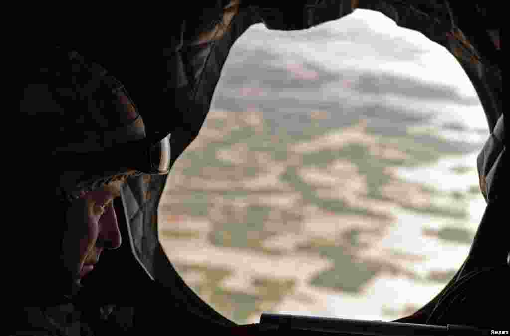 Britain&#39;s Prince Charles looks through the window of a British military helicopter en route to Lashkar Gah in March 2010.