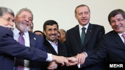 Brazilian Foreign Minister Celso Amorim (left), Brazilian President Luiz Inacio Lula da Silva, Iranian President Mahmud Ahmadinejad, Turkish Prime Minister Recep Tayyip Erdogan, and Turkish Foreign Minister Ahmet Davutoglu pose in Tehran today.