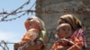 Ethnic Uzbek refugees stand at the Kyrgyz-Uzbek border crossing near Osh. Some 400,000 people have fled the violence. 