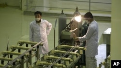 Iranian technicians work at a facility producing uranium fuel near the city of Isfahan.