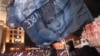 Supporters wave Putin banners on Manezh Square in Moscow soon after the polls closed on March 4, with election officials suggesting Vladimir Putin had enough votes to avoid a second-round runoff for the presidency.