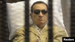 Former President Hosni Mubarak sits inside a cage in a courtroom in Cairo during sentencing on June 2. 