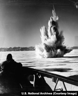 The US Navy Coastguard blasts a passage in the ice off the Greenland coast while searching for German weather stations during World War II.