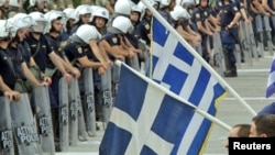 Antiausterity demonstrators confront riot police near the Greek parliament in Athens.