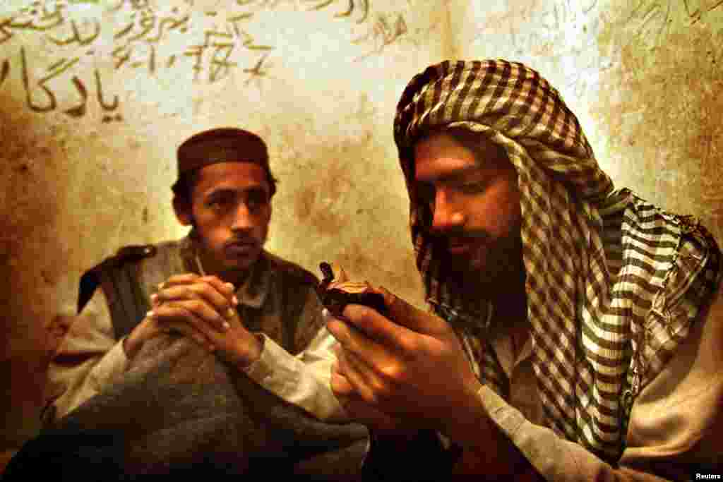 Non-Afghan Taliban read the Koran in a military jail in Kabul in November 2001.