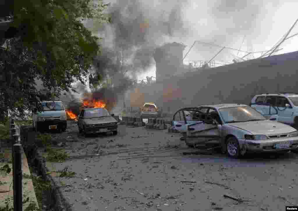 Damaged cars are seen at the site of the blast.