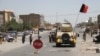 Afghan security officials and private militia members patrol in Herat on August 4.