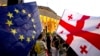 Demonstrators gather with Georgian national and EU flags during a pro-EU and anti-government rally in front of the parliament in Tbilisi on July 3.