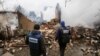 OSCE observers inspect a building that was destroyed after reported shelling in Avdiyivka in eastern Ukraine in February.