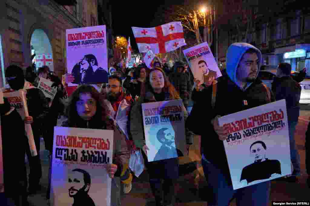 Demonstrators march in Tbilisi on February 21 demanding the release of more than 50 protesters who remain in prison.