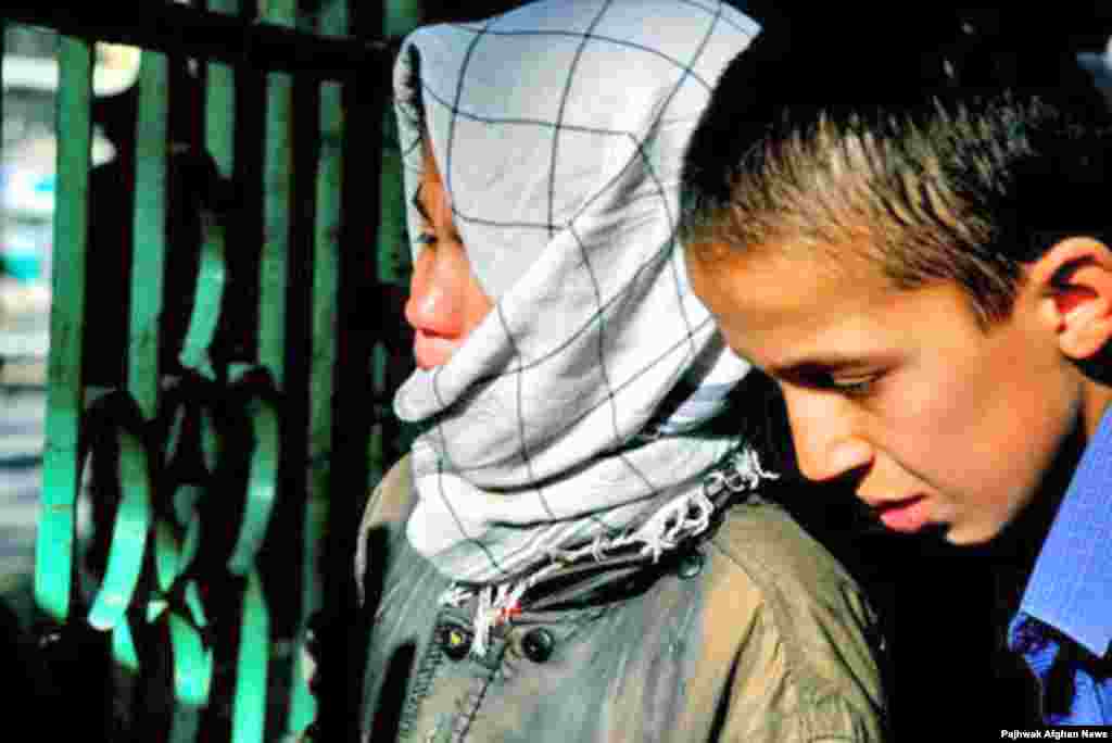 Afghan boys cry for a missing father, feared among the victims of a bomb attack on Kabul by militants in September 2007.